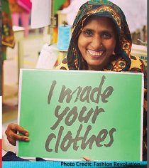 Woman holding a sign that reads I made your clothes