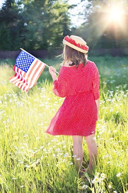 woman-outside-red-dress-hat-american-flag