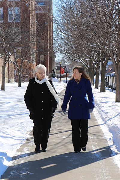 Sister Jean Kasparbauer and affiliate Ashley Skoczynski take a winter walk around St. Rose