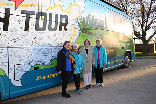 Pat Ruda and Sisters Betty Daugherty, Nancy Hoffman and Joann Gehling pictured with the Nuns on a Bus tour bus