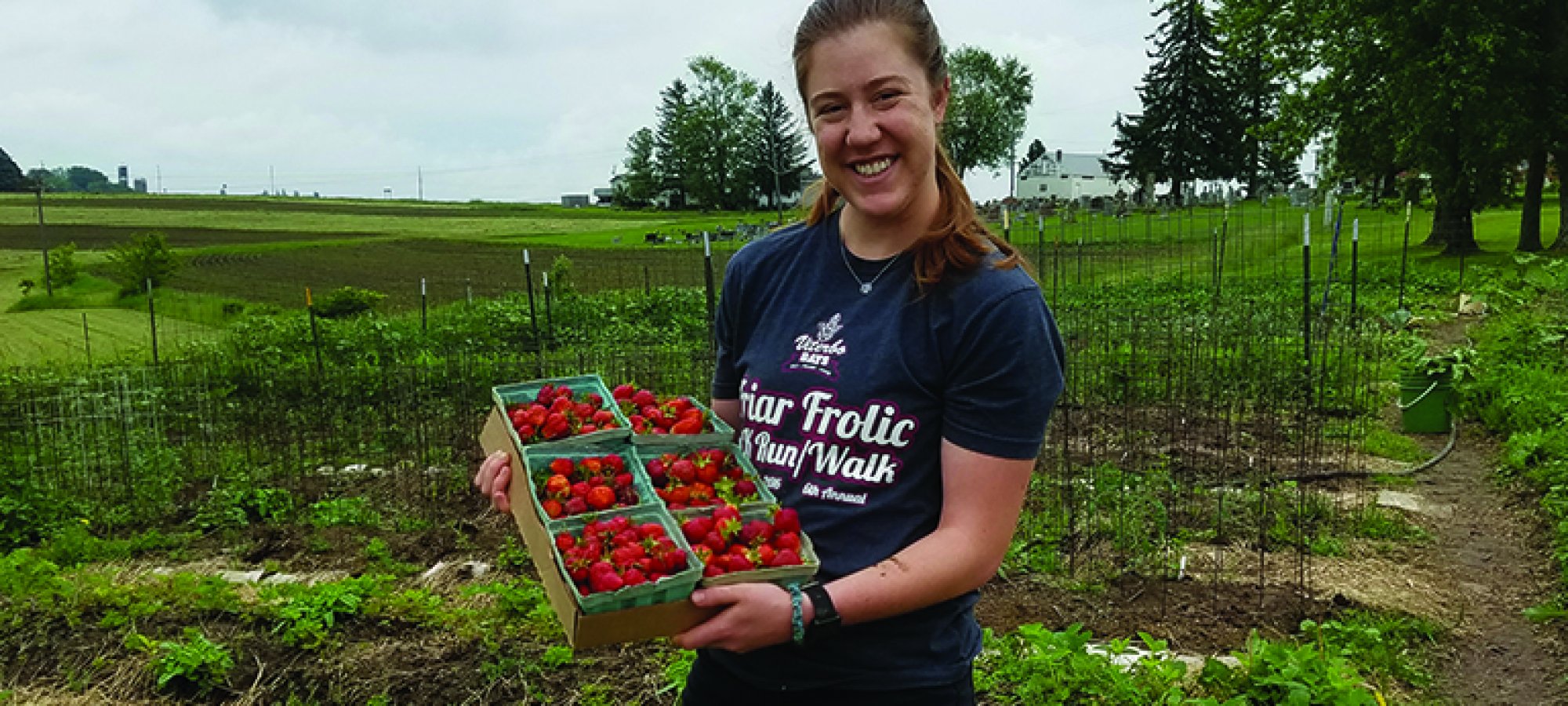 Hannah with strawberry harvest