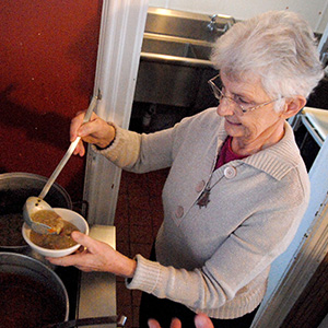 Sister Antona serving a bowl of soup at Place of Grace