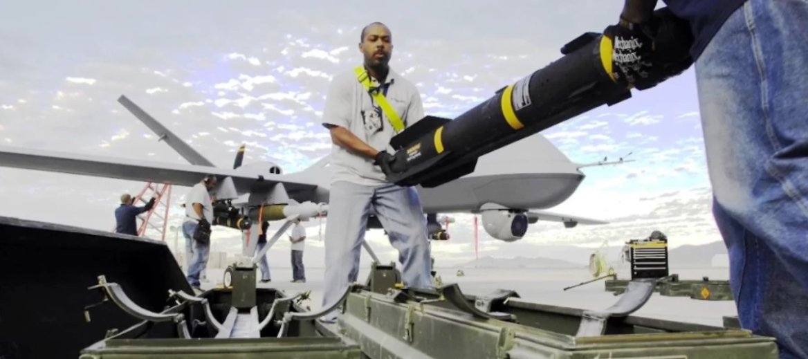 man loading drone on aircraft