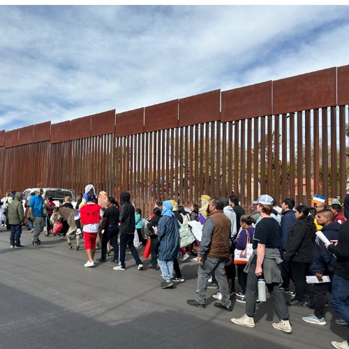 people process along the border wall in Nogales Mexico for the posada