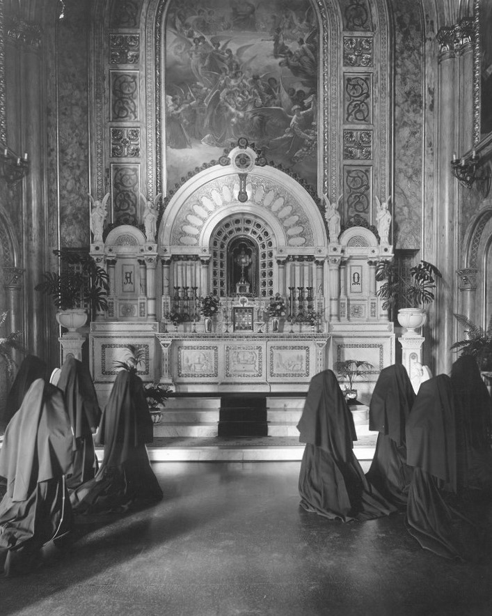 franciscan sisters of perpetual adoration in religious habits kneel before the blessed sacrament during perpetual adoration