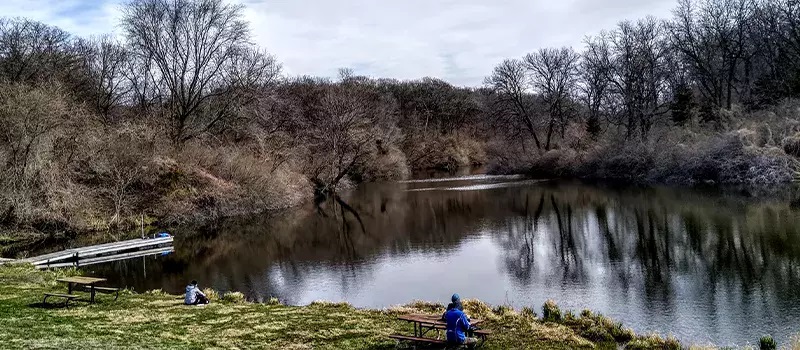 guests sitting near lake at the naturalist school