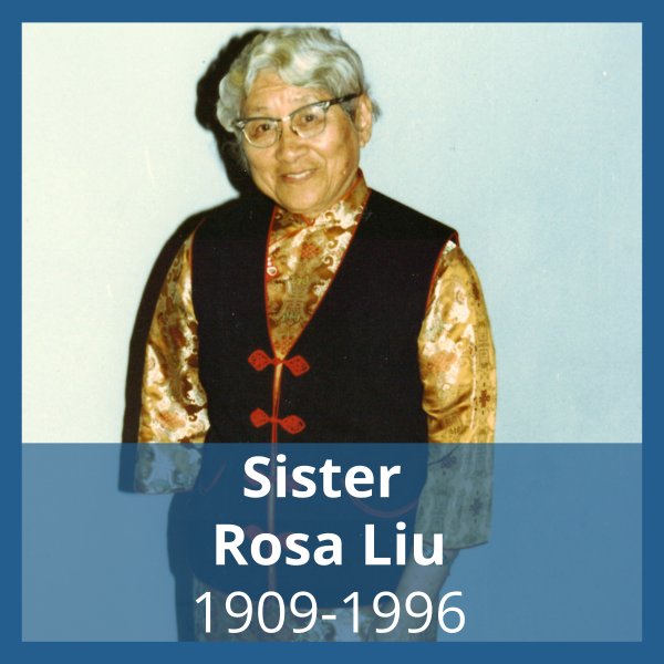 Photo, framed in dark blue, of a woman with short gray hear, wearing eyeglasses, satin blouse and black vest with red clasps standing in front of a white wall