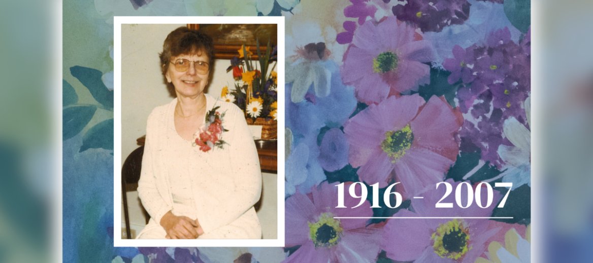Photograph of a woman with short brown hair and glasses wearing white and a pink corsage beside a colorful flower arrangement over a pastel watercolor painting of blue, green, pink, purple, yellow and white flowers