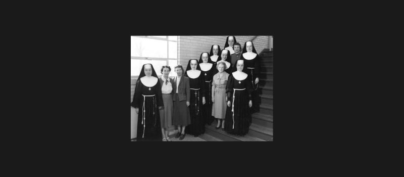 12 female teachers including catholic sisters in habit from Blessed Sacrament school pose on stairwell for this photo taken 1953-54