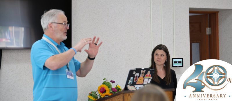 Steve Spilde and Kristina Kaiser speaking during SDPP's fall gathering, including 40th anniversary logo bottom right