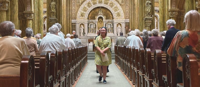 Stephanie walks down the aisle of Mary of the Angels Chapel