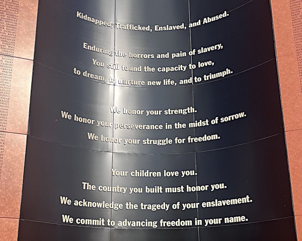 Slave monument with quote engraved with names at the National Memorial for Peace and Justice in Montgomery, Alabama