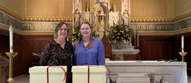 meg paulino and sidney paulson stand in front of the white sealed boxes containing thea bowman documents