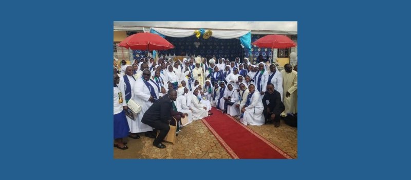the tertiary sisters of st francis pose with the bishop of kumbo diocese during a celebration