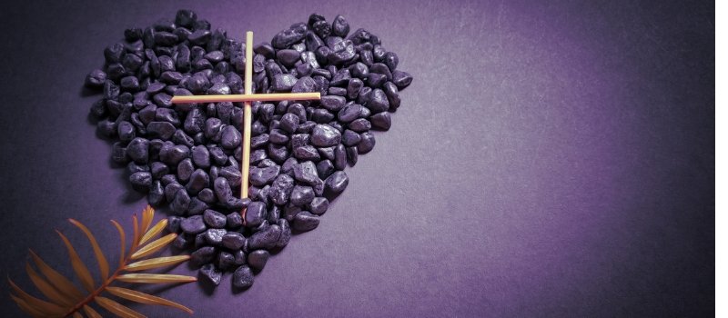 heart made of purple stones with a cross on top