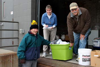 Sister Laurie Sullivan and Metro Catholic Outreach volunteers prepare food for distribution