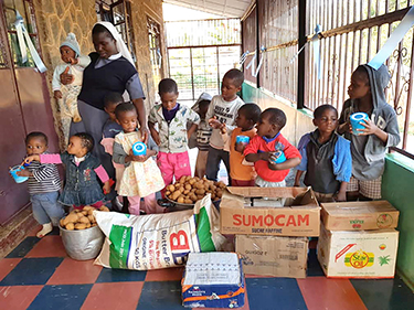 Group of children and caretaker in Cameroon Africa thank FSPA for donations