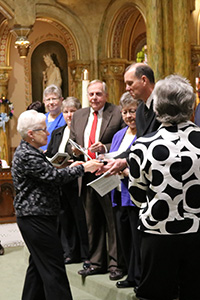 Sister Karen Lueck shakes Nick Badding's hand