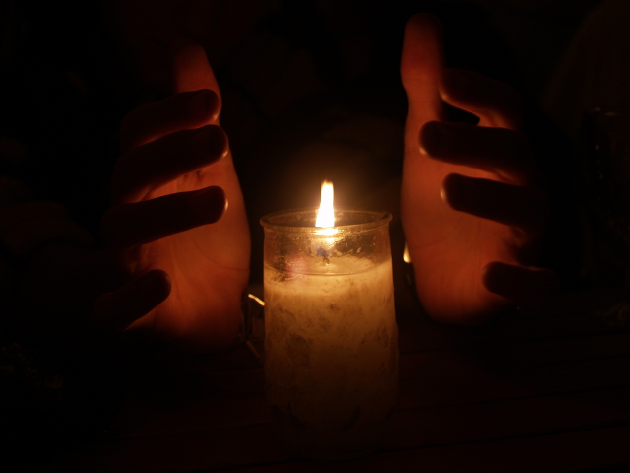 hands-lit-candle-courtesy-freeimages.com