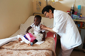 Lay mission helper nurses child