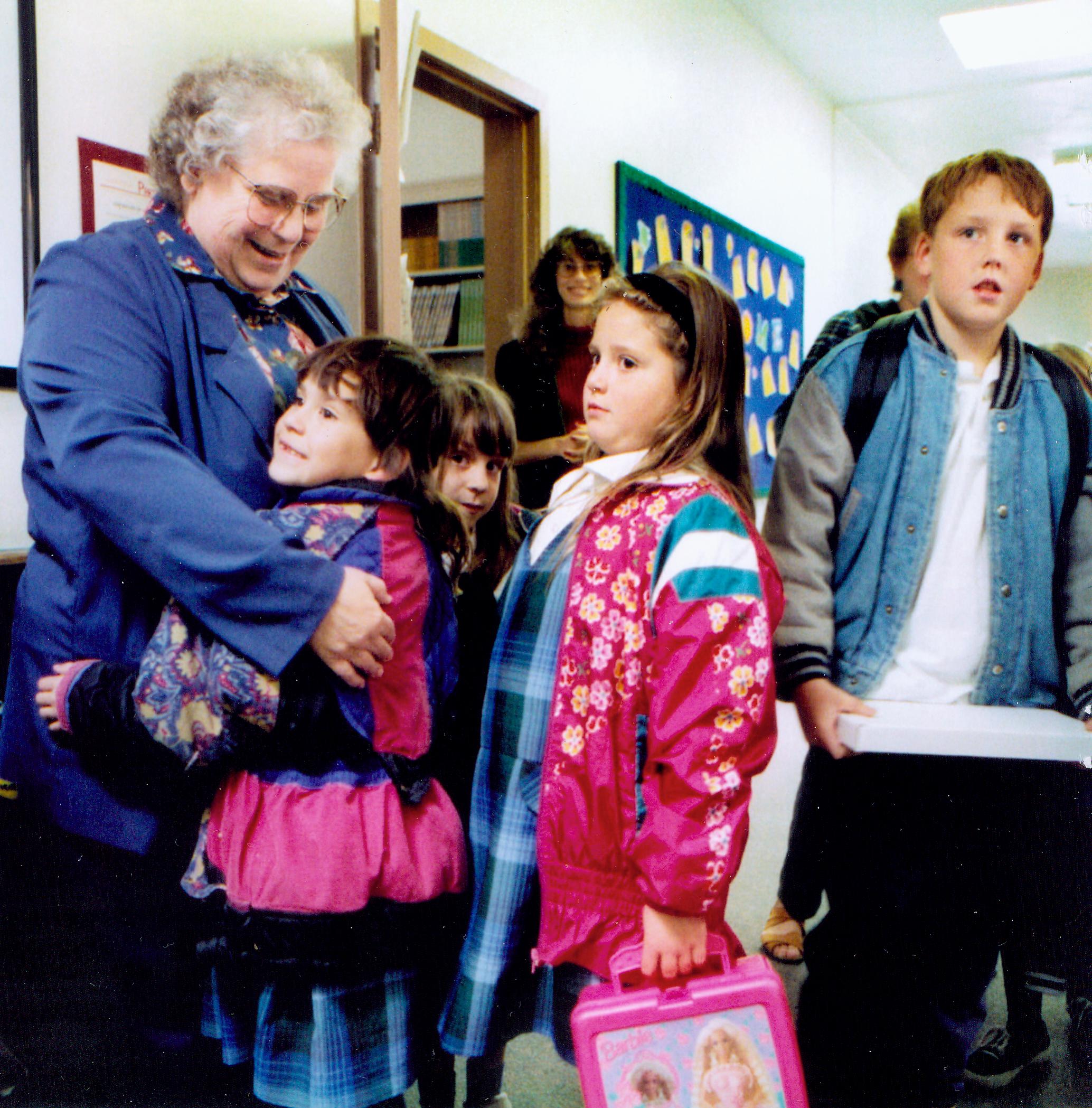 Sister Loretta hugs students