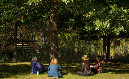 Group enjoying time under the trees at Prairiewoods