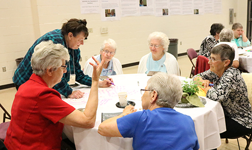 revolutionaries gather around a table and tell stories, share wisdom and discuss the next steps for our common community 