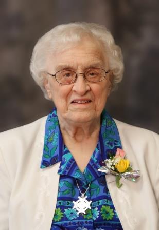 elderly-woman-white-hair-glasses-white-jacket-corsage