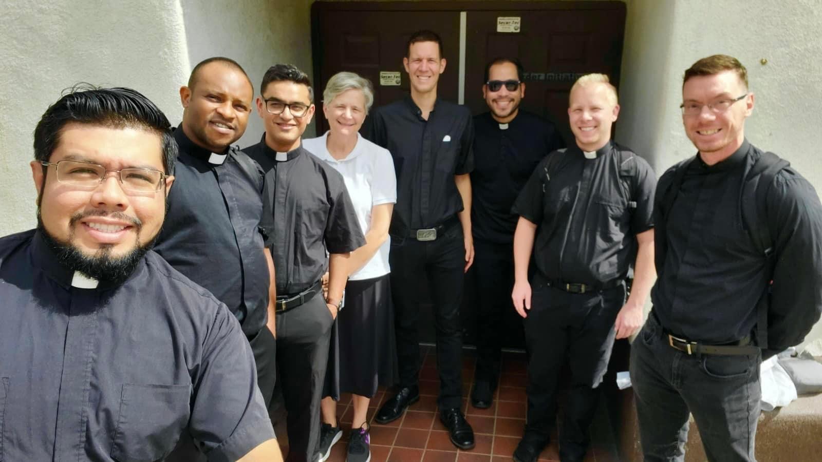 Sister Katie posing with seminarians from Mudelein Seminary