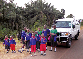 Children standing by new vehicle