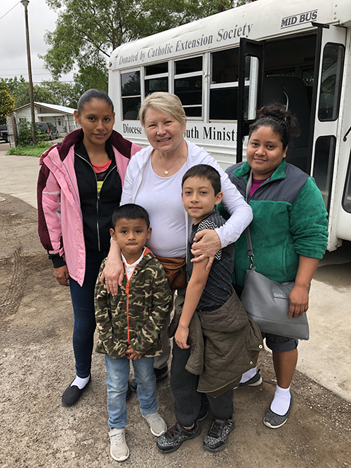 Sister Fran Ferder with refugees about to board a bus