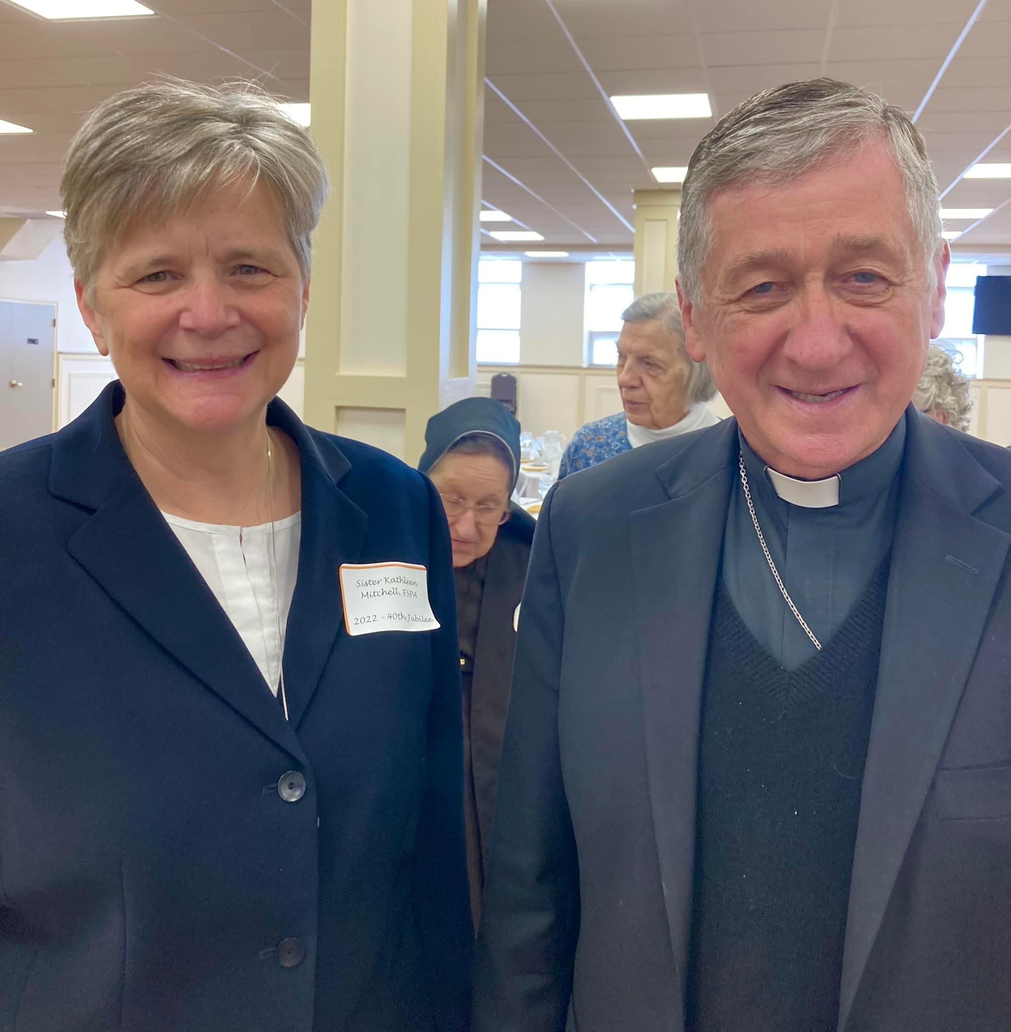 Sister Katie Mitchell poses with a priest during her 40th jubilee celebration