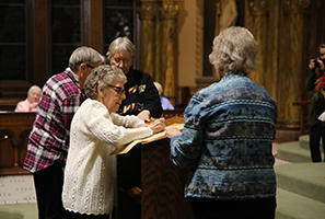 sisters signing scroll in adoration ritual