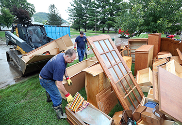 Shelby fire department, load destroyed items from flooding